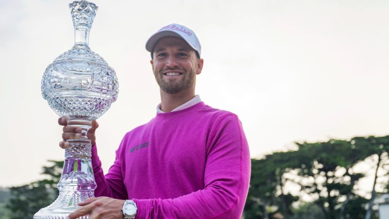 Wyndham Clark holds the trophy after winning the AT&T Pebble Beach National Pro-Am golf tournament in Pebble Beach, Calif., Monday, Feb. 5, 2024. Clark was declared the 54-hole winner at the first full signature event of the PGA Tour season when rain and dangerous wind postponed the final round on Sunday, and then tour and Monterey County officials decided it was too dangerous to play on Monday. (Nic Coury/AP)