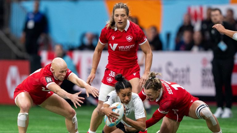 Canada's Krissy Scurfield, right, takes down New Zealand's Risi Pouri-Lane as Canada's Olivia Apps, left, and Caroline Crossley watch during Vancouver Sevens women's rugby semifinal action, in Vancouver, on Sunday, Feb. 25, 2024. (Ethan Cairns/CP)