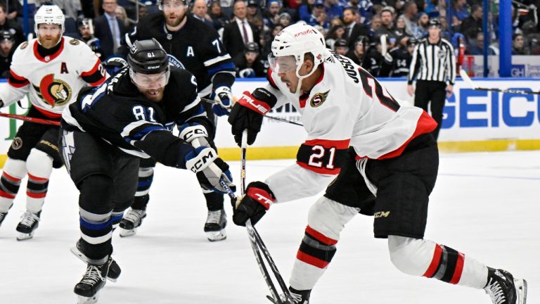 Ottawa Senators right wing Mathieu Joseph (21) scores as Tampa Bay Lightning defenseman Erik Cernak (81) defends during the first period of an NHL hockey game Monday, Feb. 19, 2024, in Tampa, Fla. (Jason Behnken/AP)