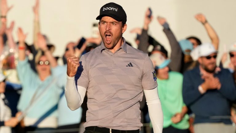 Nick Taylor, of Canada, celebrates a regulation-tying birdie putt on the 18th hole, forcing a playoff with Charley Hoffman, during the final round of the Phoenix Open golf tournament Sunday, Feb. 11, 2024, in Scottsdale, Ariz. (AP)