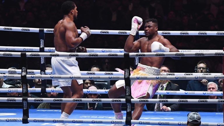 MMA fighter Francis Ngannou, right, falls during his fight with British former world champion Anthony Joshua during a heavyweight boxing showdown at Kingdom Arena in Riyadh, Saudi Arabia. (AP Photo)