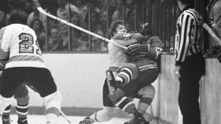 Philadelphia Flyers center Bobby Clarke (16) pushes Montreal Canadiens defenseman Bob Murdoch (23) into the boards in the third period of an NHL semifinal playoff game, April 22, 1973 in Philadelphia. Murdoch's family says the two-time Stanley Cup champion suffered from chronic traumatic encephalopathy, a progressive and fatal disease associated with repeated traumatic brain injuries. (CP/AP:
Anonymous)