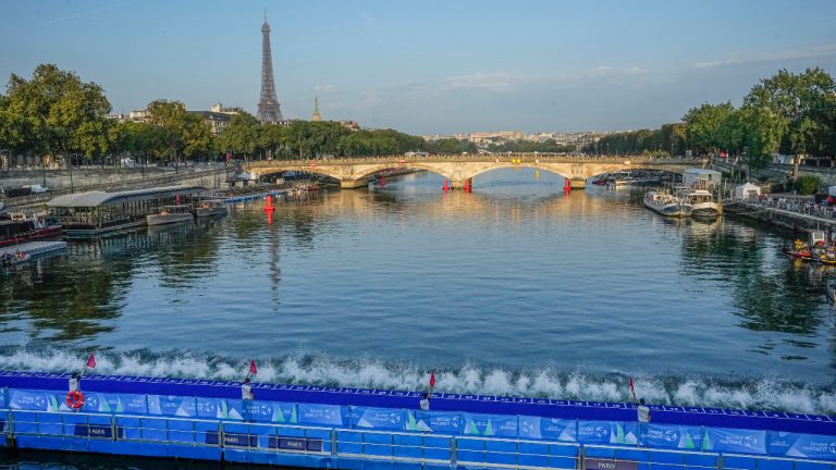 Athletes dive into the Seine river from the Alexander III bridge on the start of the first leg of the women's triathlon test event for the Paris 2024 Olympics Games in Paris, Thursday, Aug. 17, 2023. In 2024. (Michel Euler/AP) 