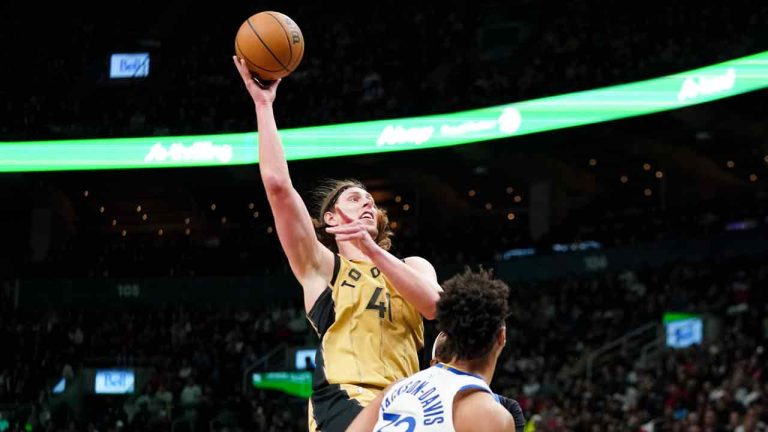 Toronto Raptors forward Kelly Olynyk (41) shoots as Golden State Warriors forward Trayce Jackson-Davis (32) looks on during second half NBA basketball action in Toronto on Friday, March 1, 2024. (Arlyn McAdorey/CP)