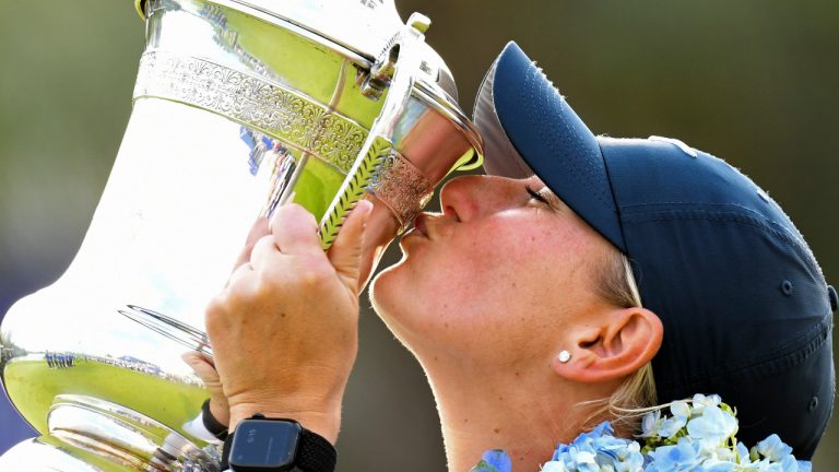 In this photo released by Xinhua News Agency, Bailey Tardy of the United States kisses the trophy after winning the Blue Bay LPGA golf tournament in Lingshui, southern China's Hainan province on Sunday, March 10, 2024. (Yang Guanyu/Xinhua via AP) 