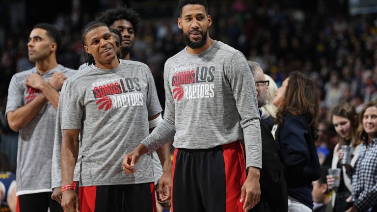 Toronto Raptors guard Jahmi'us Ramsey and forward Garrett Temple (14) in the first half of an NBA basketball game Monday, March 11, 2024, in Denver. (AP Photo/David Zalubowski)