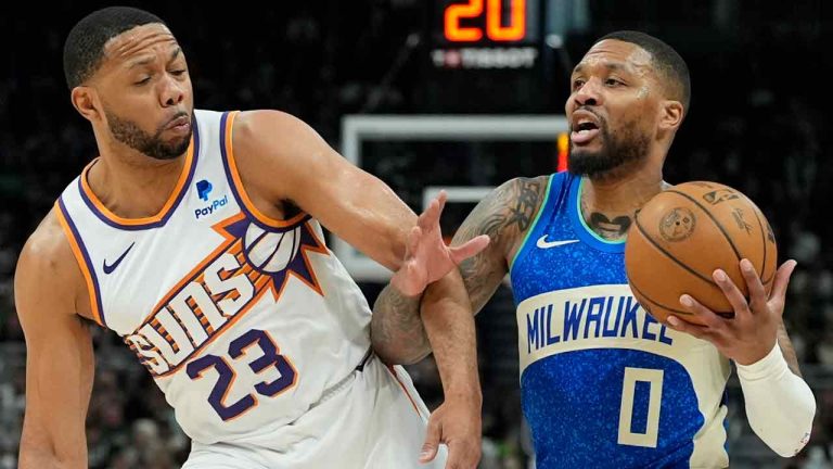 Milwaukee Bucks' Damian Lillard is fouled by Phoenix Suns' Eric Gordon during the second half of an NBA basketball game Sunday, March 17, 2024, in Milwaukee. The Bucks won 114-105.The Bucks won 140-129. (Morry Gash/AP)