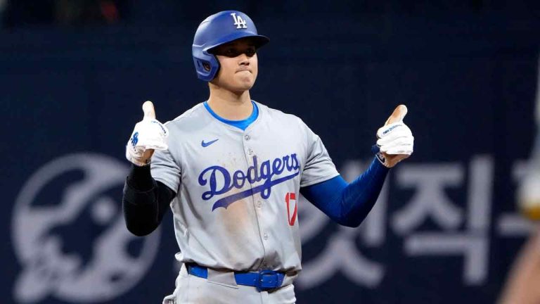 Los Angeles Dodgers designated hitter Shohei Ohtani gestures after hitting a single during the third inning of an opening day baseball game against the San Diego Padres at the Gocheok Sky Dome in Seoul, South Korea Wednesday, March 20, 2024, in Seoul, South Korea. (Ahn Young-joon/AP)