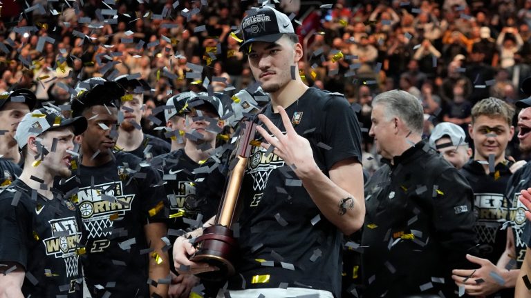 Purdue centre Zach Edey holds an NCAA Regional Championship trophy after an Elite Eight college basketball game against Tennessee in the NCAA Tournament, Sunday, March 31, 2024, in Detroit. (Paul Sancya/AP)