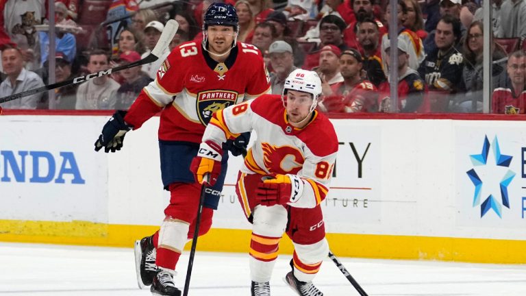 Calgary Flames left wing Andrew Mangiapane (88) skates with the puck as Florida Panthers centre Sam Reinhart (13) pursues during the first period of an NHL hockey game, Saturday, March 9, 2024, in Sunrise, Fla. (Lynne Sladky/AP)