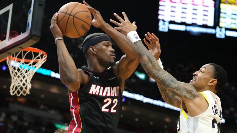 Miami Heat forward Jimmy Butler (22) looks to pass as Utah Jazz forward John Collins (20) defends during the first half of an NBA basketball game, Saturday, March 2, 2024, in Miami. (Lynne Sladky/AP)