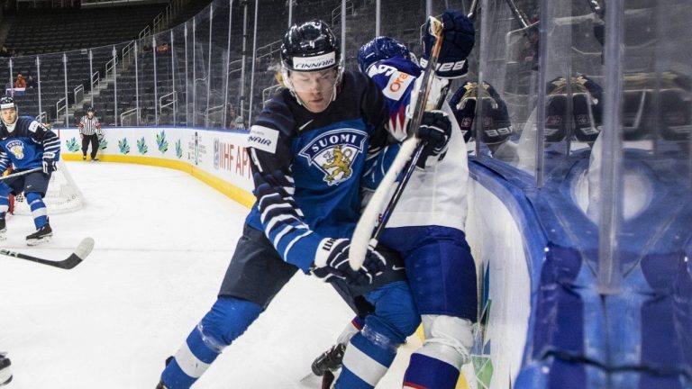 Finland's Joni Jurmo (4) checks Slovakia's Roman Faith (9) during third period IIHF World Junior Hockey Championship action in Edmonton on Sunday, August 14, 2022. The Calgary Flames have signed defenceman Jurmo to an entry level contract. (CP/Jason Franson)