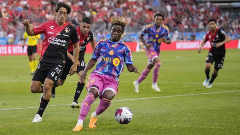 Toronto FC's Latif Blessing, right, moves the ball against Atlas FC's Jose Abella during first half Leagues Cup soccer action. (Mark Blinch/THE CANADIAN PRESS)