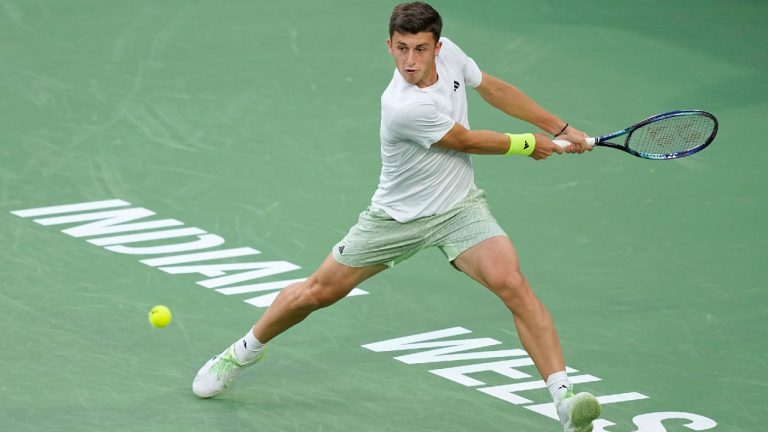 Luca Nardi, of Italy, returns a shot against Novak Djokovic, of Serbia, at the BNP Paribas Open tennis tournament, Monday, March 11, 2024, in Indian Wells, Calif. (Mark J. Terrill/AP)