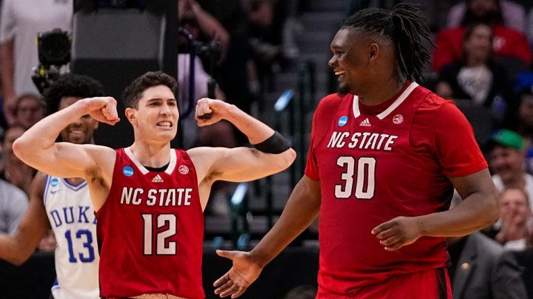 North Carolina State's Michael O'Connell (12) reacts after a basket by DJ Burns Jr. (30) against Duke during the second half of an Elite Eight college basketball game in the NCAA Tournament in Dallas, Sunday, March 31, 2024. (Tony Gutierrez/AP)