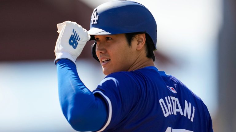 Los Angeles Dodgers designated hitter Shohei Ohtani stands on third base during the first inning of a spring training baseball game against the Colorado Rockies in Phoenix, Sunday, March 3, 2024. (Ashley Landis/AP)