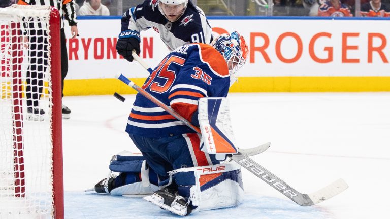 Winnipeg Jets' Cole Perfetti (91) scores the shootout goal against Edmonton Oilers goalie Olivier Rodrigue (35) during third period NHL preseason action in Edmonton on Sunday September 24, 2023. (Jason Franson/CP)