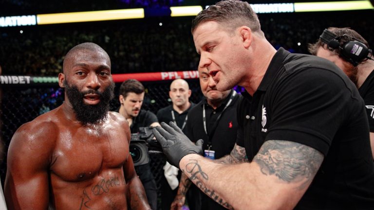 Cedric Doumbe, left, listens to mixed martial arts referee Marc Goddard after a PFL Europe main event was stopped after Doumbe sustained a bizarre injury when a piece of glass got stuck in his toe during the fight. (PFL MMA)