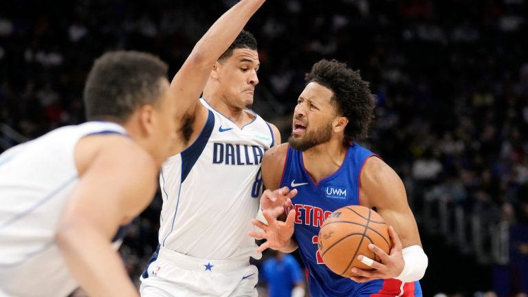 Detroit Pistons guard Cade Cunningham is defended by Dallas Mavericks guard Josh Green during the first half of an NBA basketball game, Saturday, March 9, 2024, in Detroit. (Carlos Osorio/AP Photo)