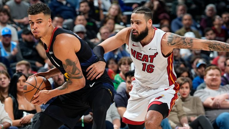 Denver Nuggets forward Michael Porter Jr., left, looks to pass the ball as Miami Heat forward Caleb Martin defends during the second half of an NBA basketball game Thursday, Feb. 29, 2024, in Denver. (David Zalubowski/AP)