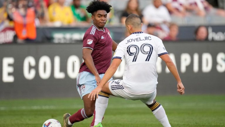 Colorado Rapids midfielder Ralph Priso, left, passes the ball as LA Galaxy forward Dejan Joveljic defends during the first half of an MLS soccer match Saturday, July 16, 2022, in Commerce City, Colo. The Vancouver Whitecaps have acquired Canadian midfielder Priso from the Colorado Rapids. (David Zalubowski/CP)