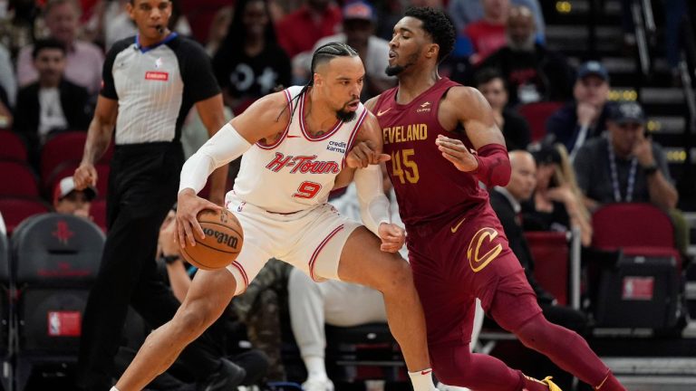 Houston Rockets' Dillon Brook works for position against Cleveland Cavaliers' Donovan Mitchell during the first half of an NBA basketball game Saturday, March 16, 2024, in Houston. (David J. Phillip/AP Photo)