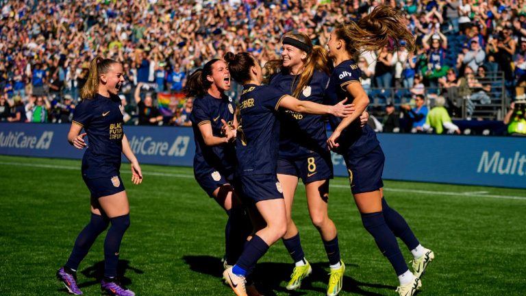 Seattle Reign forward Bethany Balcer, second from right, celebrates her goal on a penalty kick with teammates, including Lily Woodham, left, Phoebe McClernon, Angharad James-Turner and Jordyn Huitema during the first half of an NWSL soccer match against the Washington Spirit, Sunday, March 17, 2024, in Seattle. (Lindsey Wasson/AP)