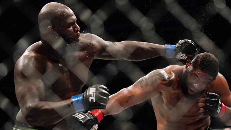 Jairzinho Rozenstruik, left, hits Curtis Blaydes during a heavyweight mixed martial arts bout at UFC 266. (John Locher/AP)