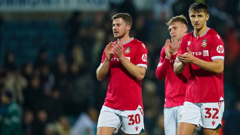 Wrexham players leave the field after the English FA Cup fourth round soccer match between Blackburn Rovers and Wrexham, at Ewood Park stadium, in Blackburn, England, Monday, Jan. 29, 2024. (Dave Thompson/AP)