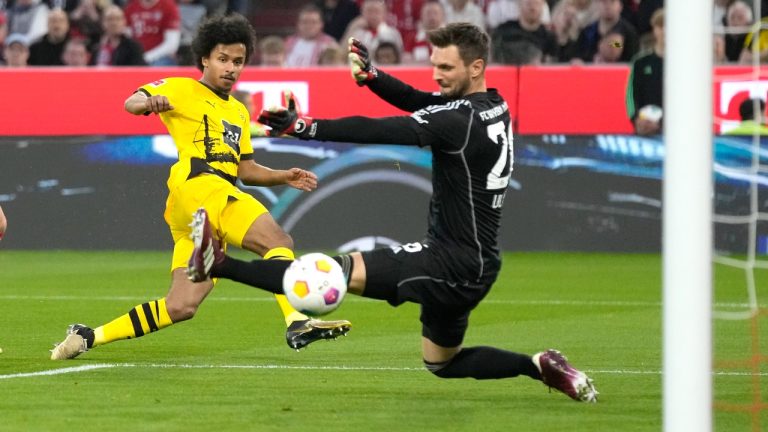 Dortmund's Karim Adeyemi scores his side's opening goal during the German Bundesliga soccer match between FC Bayern Munich and Borussia Dortmund at the Allianz Arena stadium, in Munich, Germany, Saturday, March 30, 2024. (Matthias Schrader/AP)