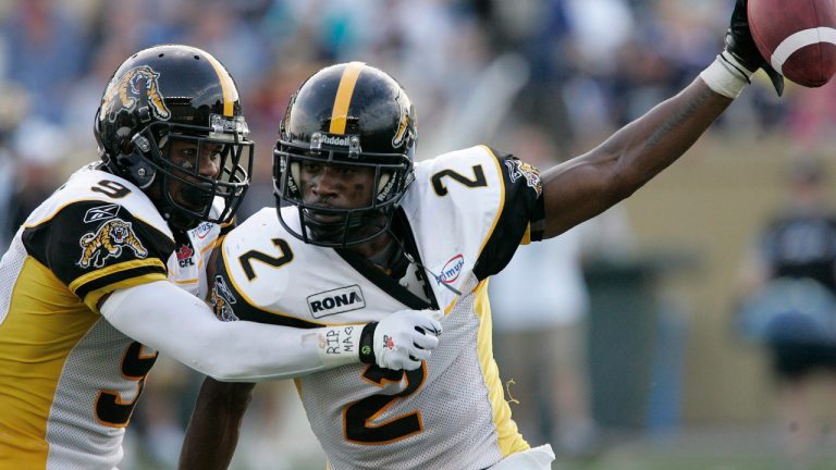 Former Tiger-Cat Jason Shivers, centre, is back with the Edmonton Elks as a coach. (John Woods/CP)