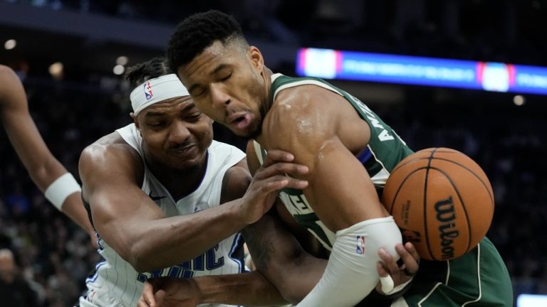 Orlando Magic's Wendell Carter Jr. and Milwaukee Bucks' Giannis Antetokounmpo go after a loose ball during the second half of an NBA basketball game Thursday, Dec. 21, 2023, in Milwaukee. The Bucks won 118-114. (Morry Gash/AP Photo)