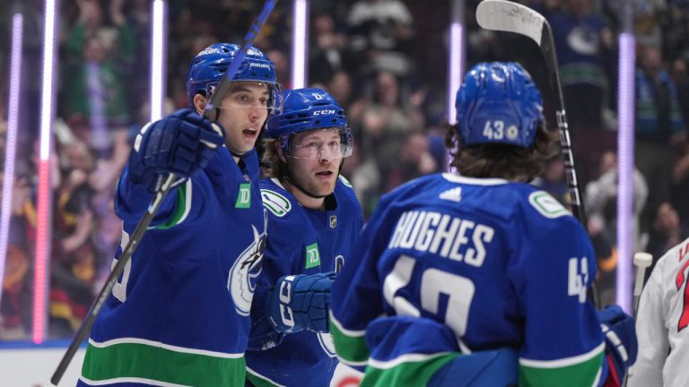 Vancouver Canucks' Brock Boeser (8) celebrates his goal against the Washington Capitals with teammates Ilya Mikheyev, left, and Quinn Hughes during first period NHL hockey action in Vancouver, B.C., Saturday, March 16, 2024. (Darryl Dyck/CP)