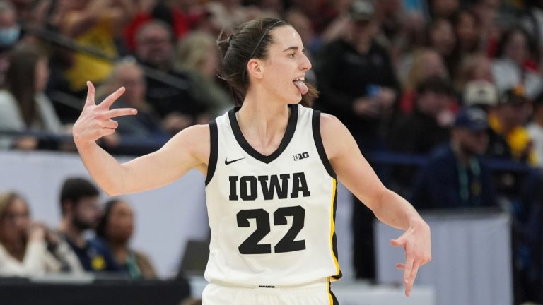 Iowa guard Caitlin Clark (22) celebrates after making a 3-point basket during the first half of an NCAA college basketball game against Michigan in the semifinals of the Big Ten women's tournament Saturday, March 9, 2024, in Minneapolis. (Abbie Parr/AP Photo)