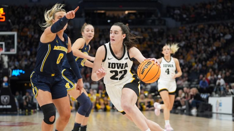 Iowa guard Caitlin Clark (22) works toward the basket as Michigan guard Elissa Brett (0) defends during the second half of an NCAA college basketball game in the semifinals of the Big Ten women's tournament Saturday, March 9, 2024, in Minneapolis. (Abbie Parr/AP)