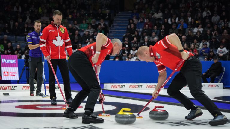 Canada skip Brad Gushue, back second left, and Alberta-Bottcher skip Brendan Bottcher, back left, watch as Canada second E.J. Harnden, front left, and third Mark Nichols sweep during the playoffs at the Brier, in Regina, on Saturday, March 9, 2024. (Darryl Dyck/CP)