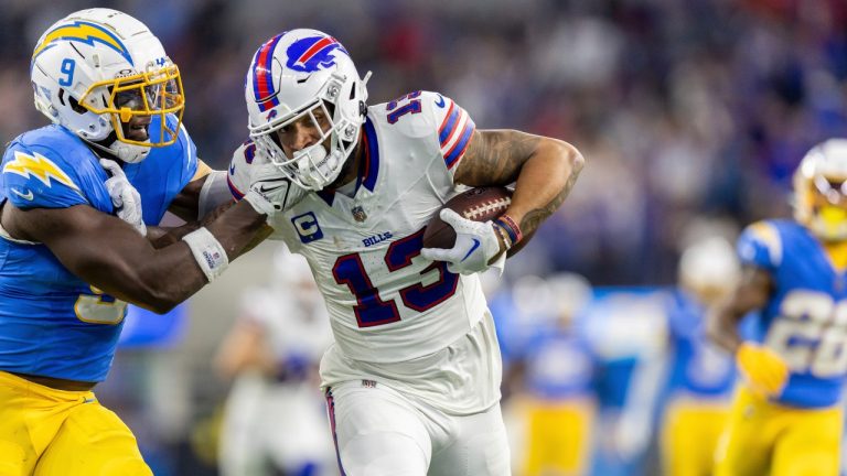 Buffalo Bills wide receiver Gabe Davis (13) catches a pass and scores a touchdown while being covered by Los Angeles Chargers' Kenneth Murray, Jr. (9) in an NFL football game, Saturday Dec. 23, 2023, in Inglewood, Calif. (Jeff Lewis/AP Photo)