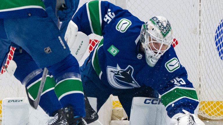 Vancouver Canucks goaltender Thatcher Demko (35) covers the puck during the first period of an NHL game against the Winnipeg Jets, in Vancouver, Saturday, March 9, 2024. (Ethan Cairns/CP)