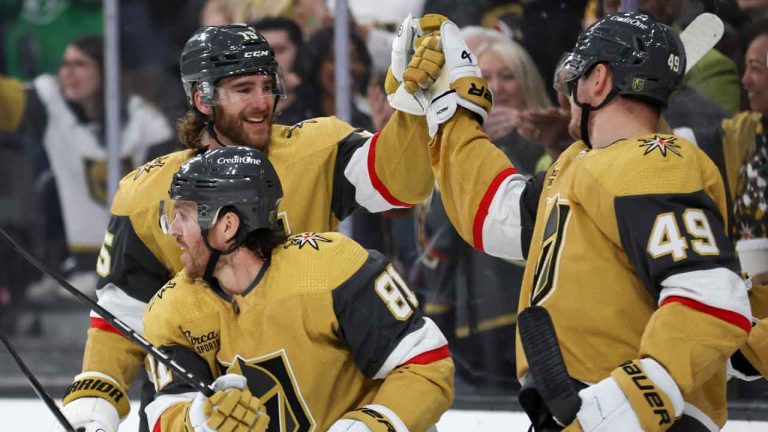 Vegas Golden Knights defenseman Noah Hanifin (15) and center Ivan Barbashev (49) bump fists over right wing Jonathan Marchessault (81) after he scored during the first period of an NHL hockey game against the Detroit Red Wings. (Ellen Schmidt/AP)