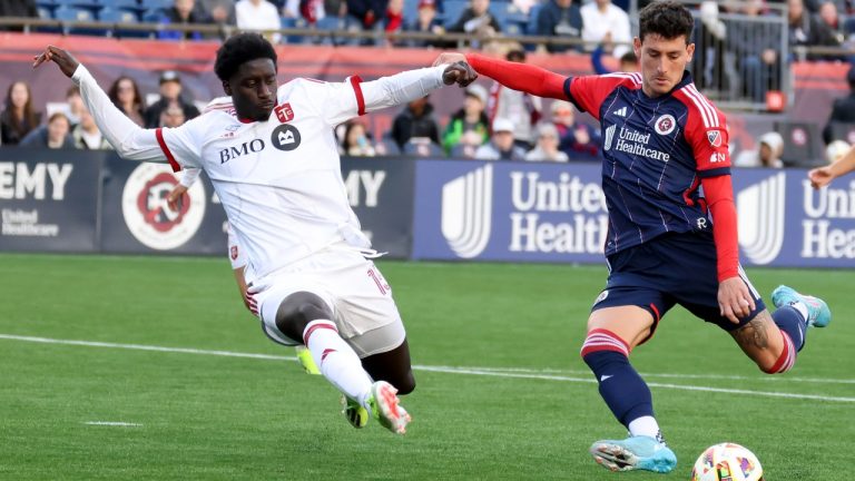 Toronto FC defender Nicksoen Gomis, left, and New England Revolution forward Tomas Chancalay, right, fight for the ball in the second half of an MLS soccer match, Sunday, March 3, 2024, in Foxborough, Mass. (Mark Stockwell/AP)