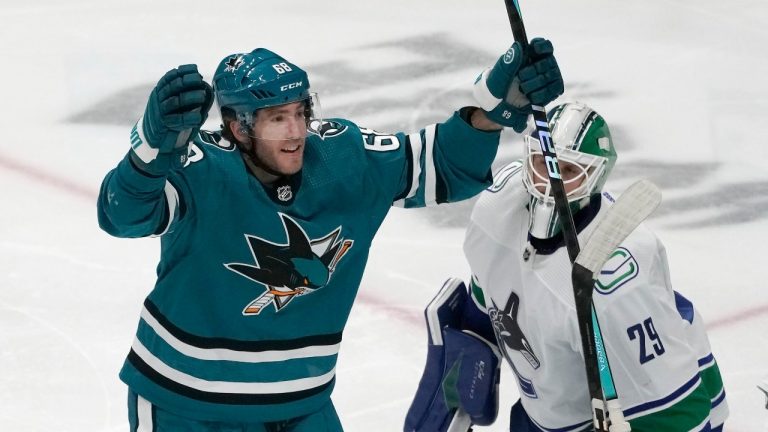 San Jose Sharks left wing Mike Hoffman, left, celebrates after scoring a goal against Vancouver Canucks goaltender Casey DeSmith (29) during the third period of an NHL hockey game in San Jose, Calif., Saturday, Nov. 25, 2023. (Jeff Chiu/AP Photo)