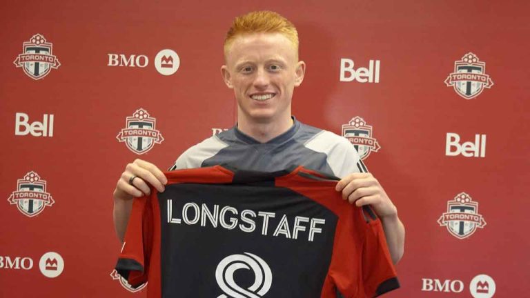 Newly-signed Toronto FC midfielder Matty Longstaff holds up his jersey after training in Toronto. (Neil Davidson/THE CANADIAN PRESS)