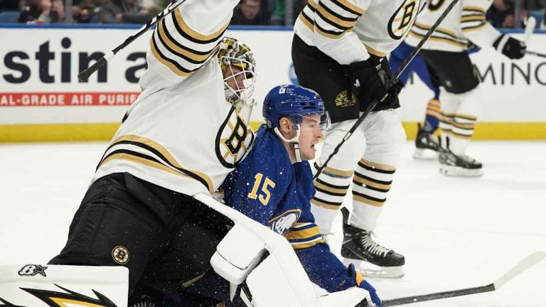 Buffalo Sabres' Brandon Biro collides with Boston Bruins goalie Michael DiPietro during the third period of an NHL hockey preseason game. (Joshua Bessex/AP)