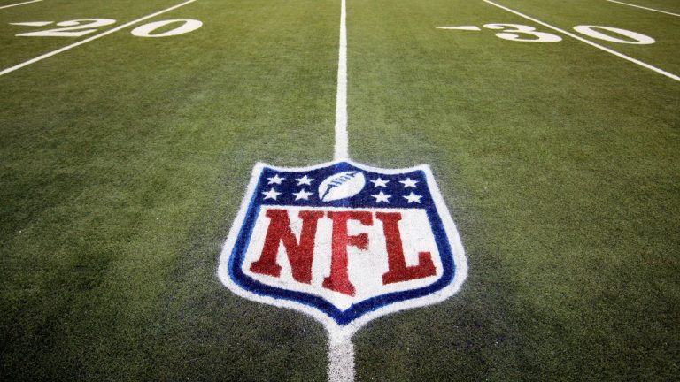 The NFL's logo as seen on a football field. (Carlos Osorio/AP)