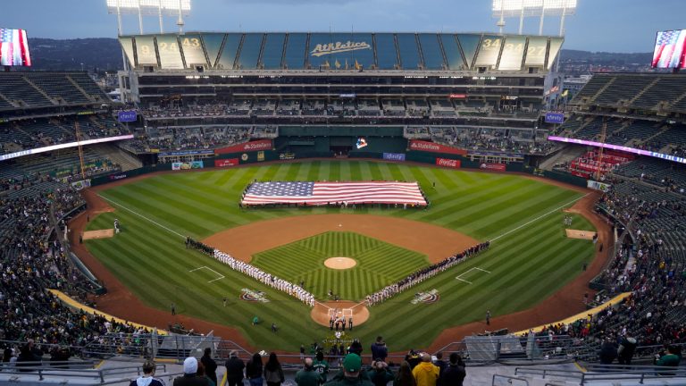 The Oakland Athletics and the Cleveland Guardians listen to the national anthem before a baseball game Thursday, March 28, 2024, in Oakland, Calif. (Godofredo A. Vásquez/AP)