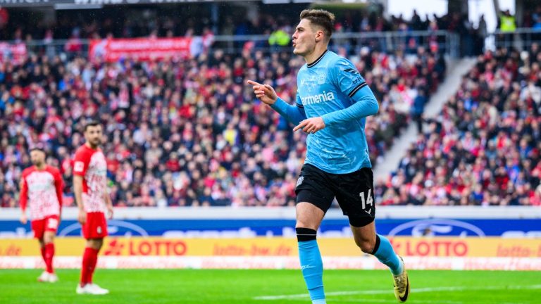 Leverkusen's Patrik Schick celebrates after scoring their side's third goal of the game during the Bundesliga soccer match between Bayer Leverkusen and SC Freiburg at the Europa-Park Stadium in Freiburg im Breisgau, Germany, Sunday March 17, 2024. (Tom Weller/dpa via AP)