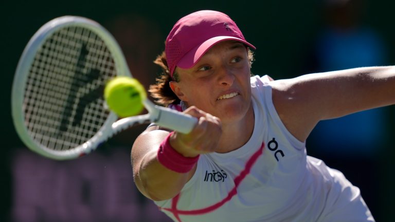 Iga Swiatek, of Poland, returns a shot against against Danielle Collins, of the United States, at the BNP Paribas Open tennis tournament in Indian Wells, Calif., Friday, March 8, 2024. (Ryan Sun/AP)