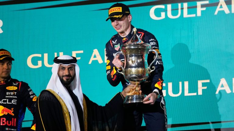 First place, Red Bull driver Max Verstappen of the Netherlands receives his trophy on the podium during the Formula One Bahrain Grand Prix at the Bahrain International Circuit in Sakhir, Bahrain, Saturday, March 2, 2024. (Darko Bandic/AP)