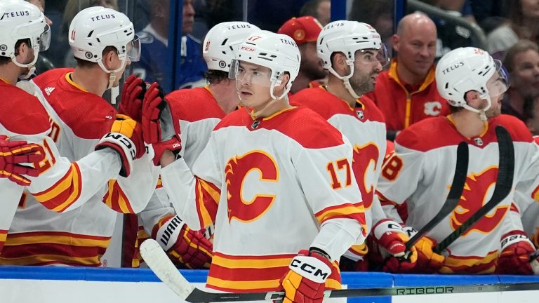 Calgary Flames centre Yegor Sharangovich (17) celebrates with the bench after scoring against the Tampa Bay Lightning during the second period of an NHL hockey game Thursday, March 7, 2024, in Tampa, Fla. (Chris O'Meara/AP Photo)