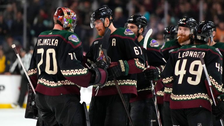 Arizona Coyotes goaltender Karel Vejmelka (70) celebrates with teammates after their win over the Seattle Kraken in an NHL hockey game, Friday, March 22, 2024, in Tempe, Ariz. (Rick Scuteri/AP)